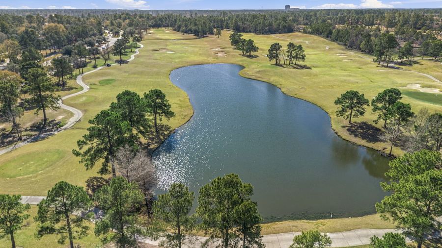 Aerial drone photo of a lake and golf course in Spring
